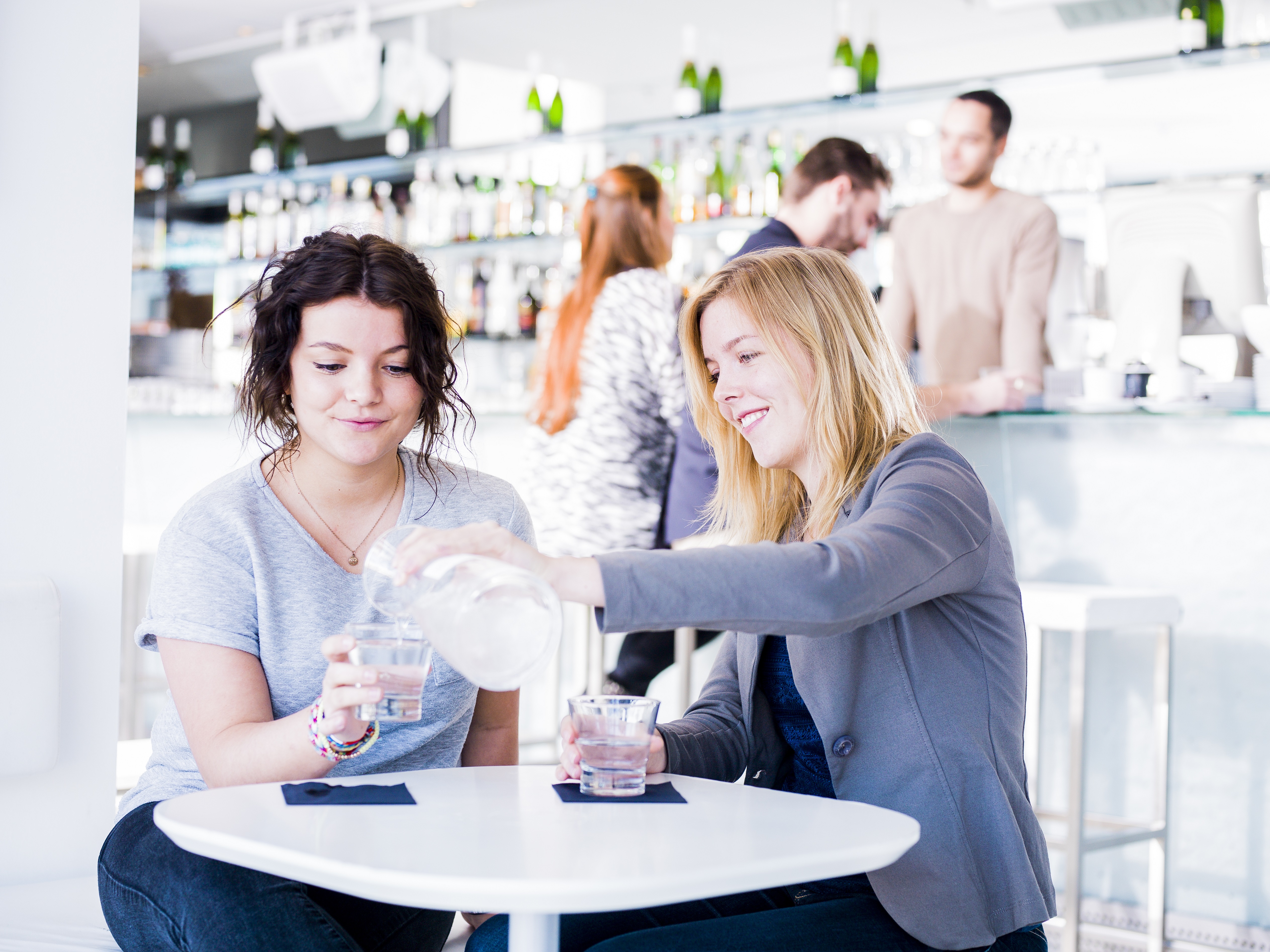 Vriendinnen drinken water in een restaurant